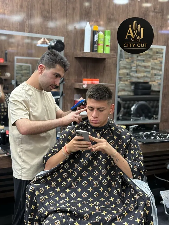 A barber cutting at the station